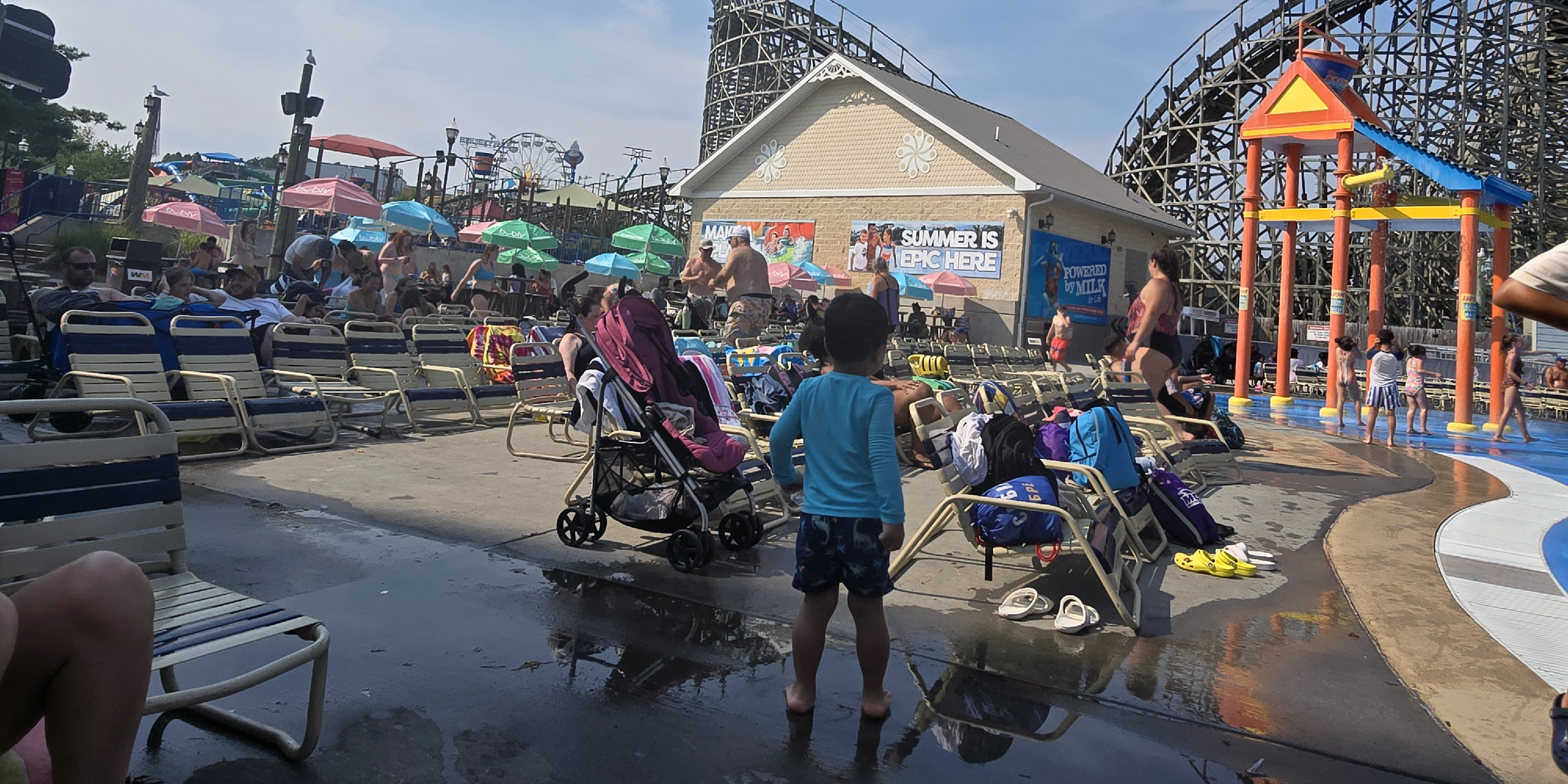 Rows of low-profile sand chairs providing parent and guest seating beside a busy waterpark splash area.